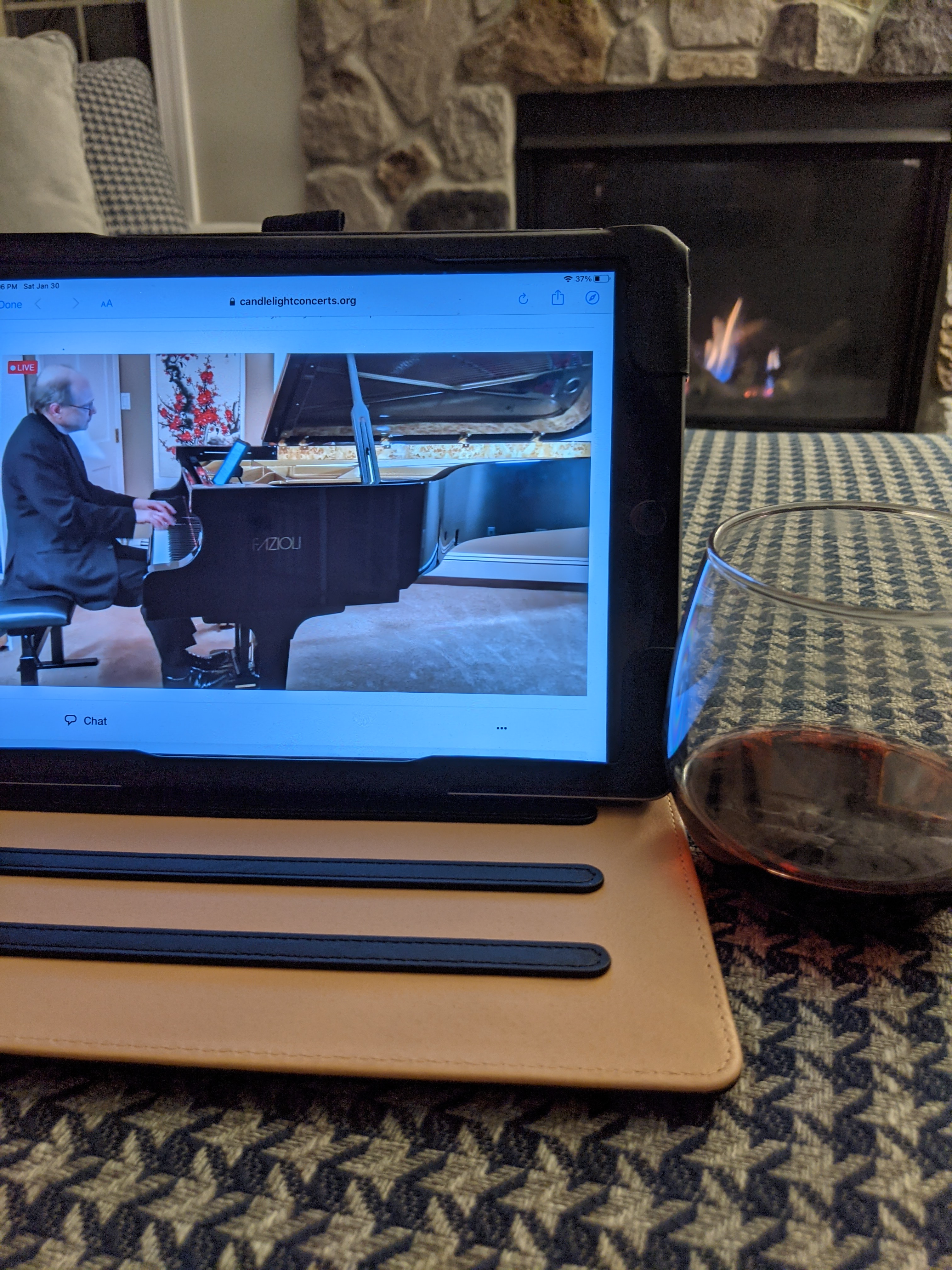 online concert, piano, male musician playing piano, wine, glass of wine, fireplace